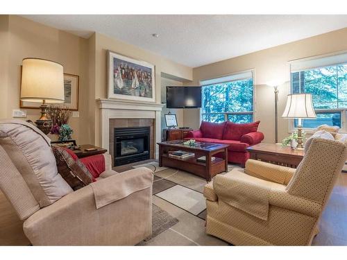 119-2144 Paliswood Road Sw, Calgary, AB - Indoor Photo Showing Living Room With Fireplace