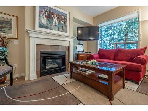 119-2144 Paliswood Road Sw, Calgary, AB - Indoor Photo Showing Living Room With Fireplace