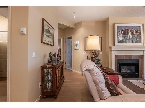 119-2144 Paliswood Road Sw, Calgary, AB - Indoor Photo Showing Living Room With Fireplace