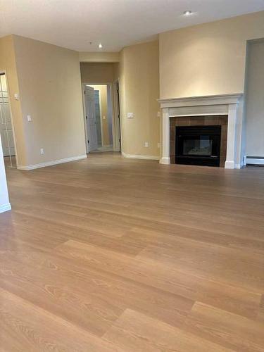 119-2144 Paliswood Road Sw, Calgary, AB - Indoor Photo Showing Living Room With Fireplace