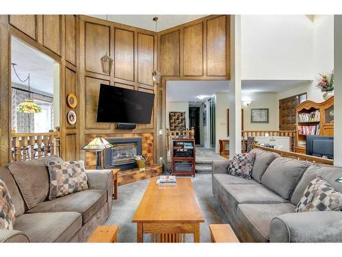 3315 Palliser Drive Sw, Calgary, AB - Indoor Photo Showing Living Room With Fireplace