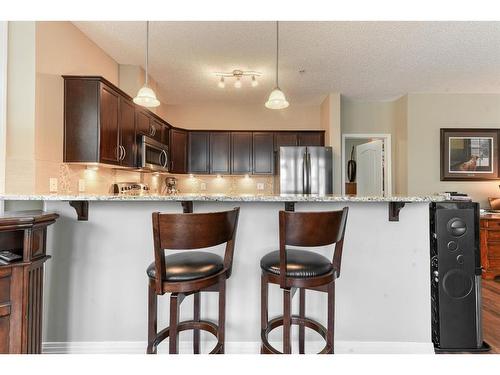 109-1 Crystal Green Lane, Okotoks, AB - Indoor Photo Showing Kitchen With Upgraded Kitchen