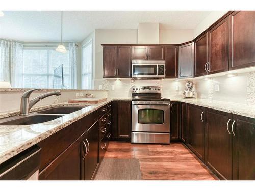 109-1 Crystal Green Lane, Okotoks, AB - Indoor Photo Showing Kitchen With Double Sink