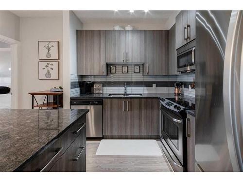 309-16 Sage Hill Terrace Nw, Calgary, AB - Indoor Photo Showing Kitchen With Double Sink