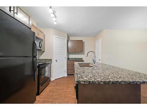 11201-2781 Chinook Winds Drive Sw, Airdrie, AB - Indoor Photo Showing Kitchen With Double Sink