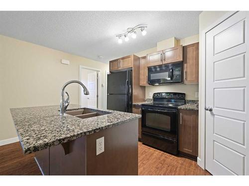 11201-2781 Chinook Winds Drive Sw, Airdrie, AB - Indoor Photo Showing Kitchen With Double Sink