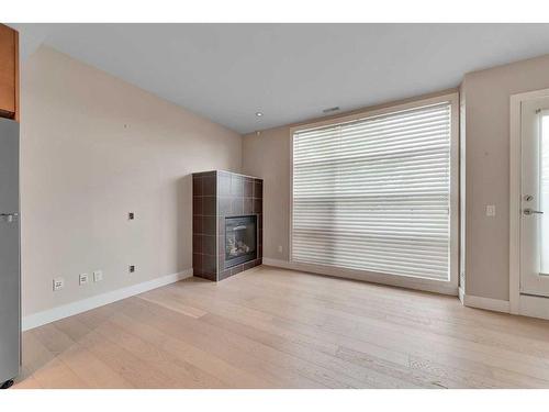 202-180 9 Street Ne, Calgary, AB - Indoor Photo Showing Other Room With Fireplace