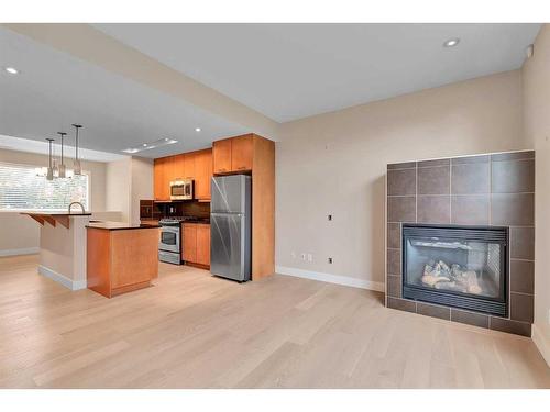 202-180 9 Street Ne, Calgary, AB - Indoor With Fireplace