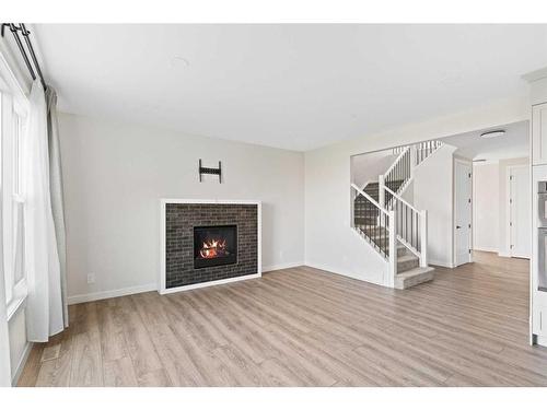 176 Sandpiper Landing, Chestermere, AB - Indoor Photo Showing Living Room With Fireplace