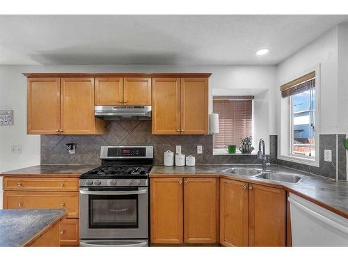 845 Luxstone Square Sw, Airdrie, AB - Indoor Photo Showing Kitchen With Double Sink