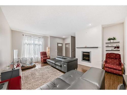 22-300 Evanscreek Court Nw, Calgary, AB - Indoor Photo Showing Living Room With Fireplace