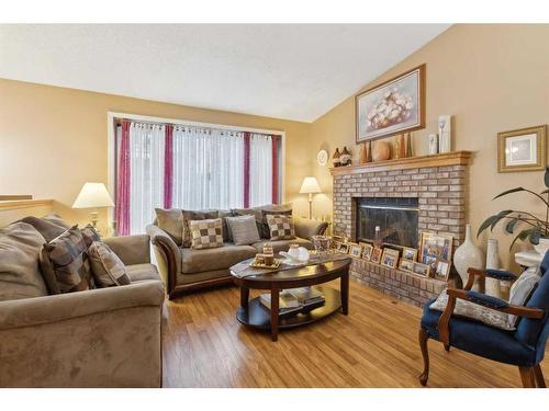 20 Shannon Hill Sw, Calgary, AB - Indoor Photo Showing Living Room With Fireplace