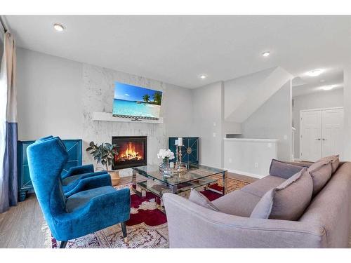 103 Masters Place Se, Calgary, AB - Indoor Photo Showing Living Room With Fireplace