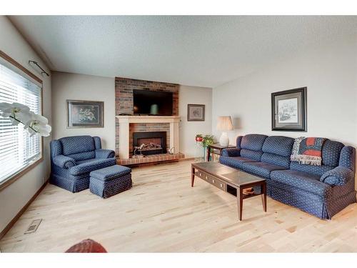 3248 Cedarille Drive Sw, Calgary, AB - Indoor Photo Showing Living Room With Fireplace