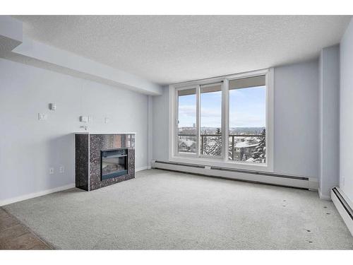 711-429 14 Street Nw, Calgary, AB - Indoor Photo Showing Other Room With Fireplace