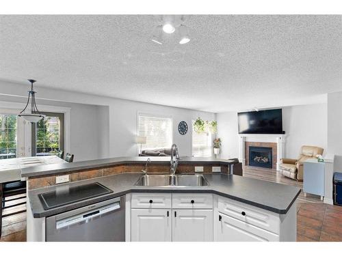 199 West Lakeview Circle, Chestermere, AB - Indoor Photo Showing Kitchen With Fireplace With Double Sink