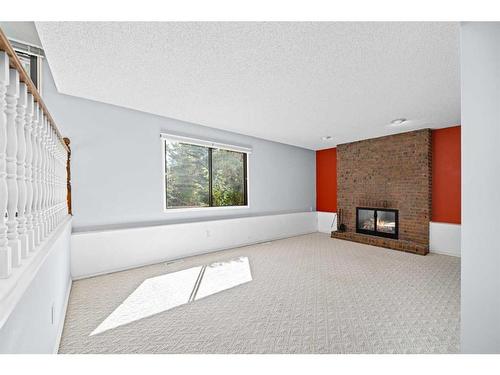 216 Ranchview Mews Nw, Calgary, AB - Indoor Photo Showing Other Room With Fireplace