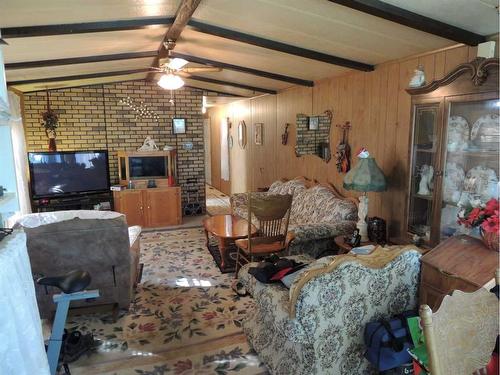 707 Highfield Drive, Carstairs, AB - Indoor Photo Showing Living Room With Fireplace