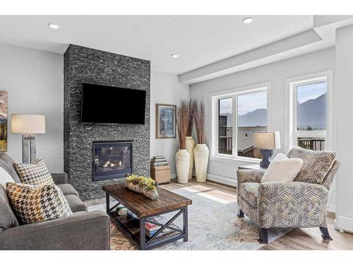 405-810 7Th Street, Canmore, AB - Indoor Photo Showing Living Room With Fireplace