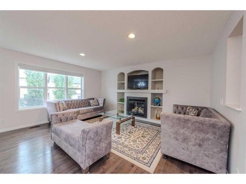 316 Morningside Crescent Sw, Airdrie, AB - Indoor Photo Showing Living Room With Fireplace