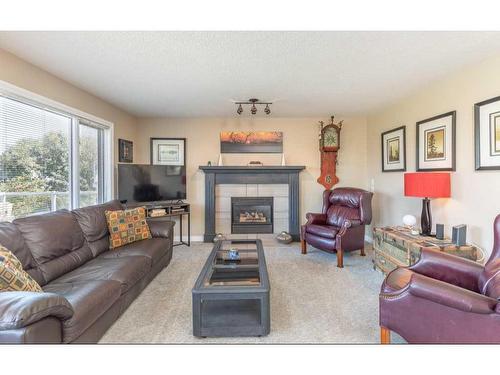 1112 High Country Drive Nw, High River, AB - Indoor Photo Showing Living Room With Fireplace