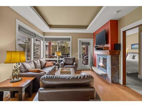 107Bf-187 Kananaskis Way, Canmore, AB - Indoor Photo Showing Living Room With Fireplace