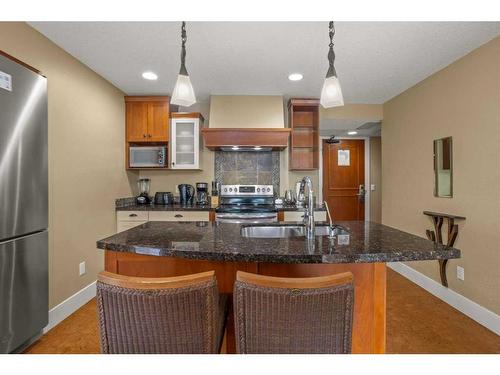 107Bf-187 Kananaskis Way, Canmore, AB - Indoor Photo Showing Kitchen With Double Sink