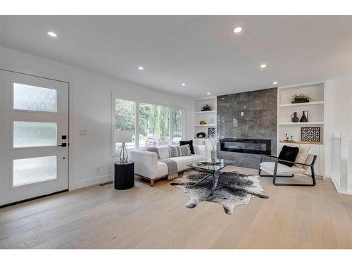 23 Hoover Place Sw, Calgary, AB - Indoor Photo Showing Living Room With Fireplace