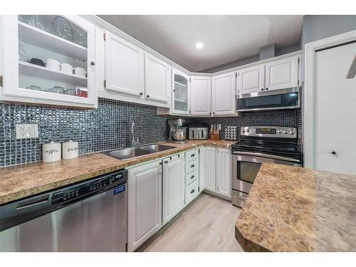 7846 20A Street Se, Calgary, AB - Indoor Photo Showing Kitchen With Stainless Steel Kitchen With Double Sink