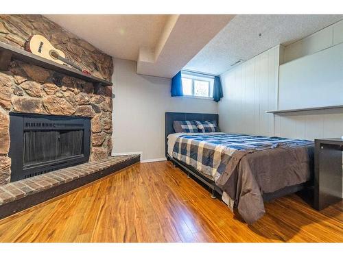 7846 20A Street Se, Calgary, AB - Indoor Photo Showing Bedroom With Fireplace