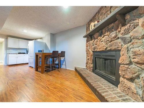 7846 20A Street Se, Calgary, AB - Indoor Photo Showing Living Room With Fireplace