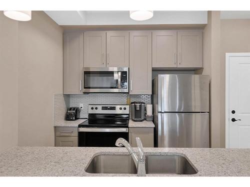 312-30 Mahogany Mews Se, Calgary, AB - Indoor Photo Showing Kitchen With Stainless Steel Kitchen With Double Sink