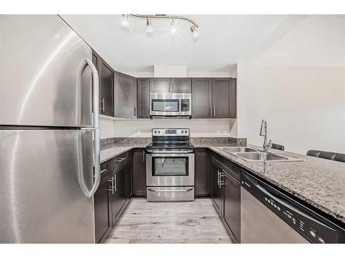 220-955 Mcpherson Road Ne, Calgary, AB - Indoor Photo Showing Kitchen With Stainless Steel Kitchen With Double Sink With Upgraded Kitchen