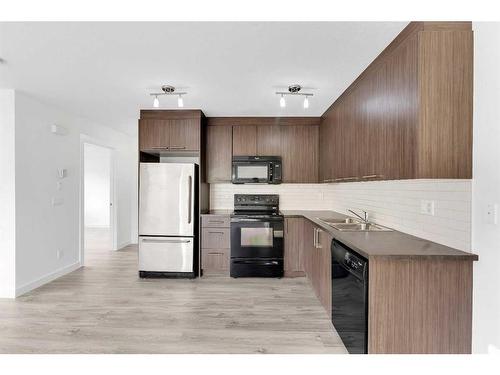 218-300 Marina Drive, Chestermere, AB - Indoor Photo Showing Kitchen With Double Sink