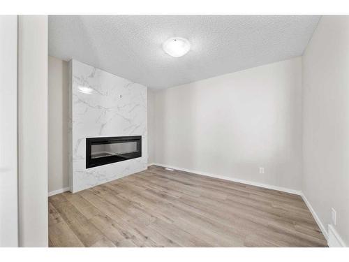 1485 148 Avenue Nw, Calgary, AB - Indoor Photo Showing Living Room With Fireplace