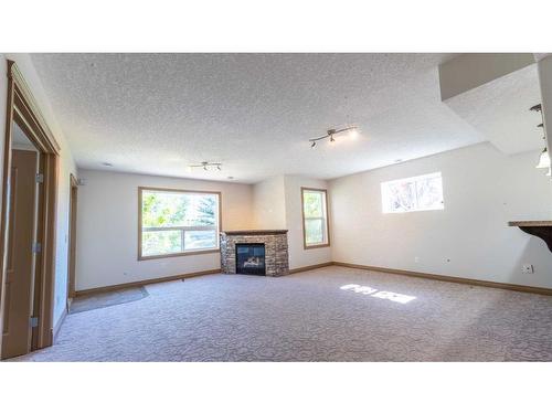 212 Sherwood Rise Nw, Calgary, AB - Indoor Photo Showing Other Room With Fireplace