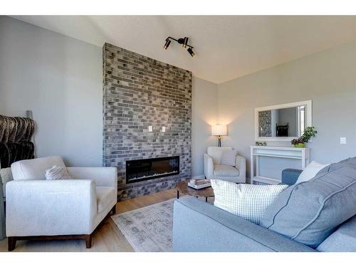 263 Precedence Hill, Cochrane, AB - Indoor Photo Showing Living Room With Fireplace