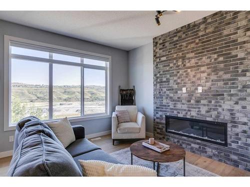 263 Precedence Hill, Cochrane, AB - Indoor Photo Showing Living Room With Fireplace