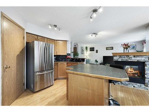 899 Somerset Drive Sw, Calgary, AB - Indoor Photo Showing Kitchen With Fireplace