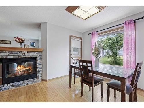 899 Somerset Drive Sw, Calgary, AB - Indoor Photo Showing Dining Room With Fireplace