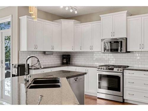 62 Crystal Green Way, Okotoks, AB - Indoor Photo Showing Kitchen With Stainless Steel Kitchen With Double Sink With Upgraded Kitchen