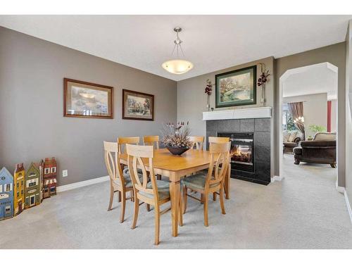 62 Crystal Green Way, Okotoks, AB - Indoor Photo Showing Dining Room With Fireplace