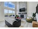 235 Precedence Hill, Cochrane, AB  - Indoor Photo Showing Living Room With Fireplace 