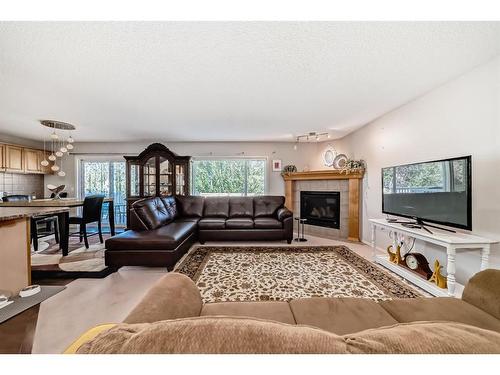 186 Everstone Drive Sw, Calgary, AB - Indoor Photo Showing Living Room With Fireplace