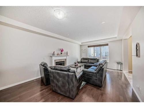 158 Windridge Road Sw, Airdrie, AB - Indoor Photo Showing Living Room With Fireplace