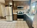 803 Whitehill Way Ne, Calgary, AB  - Indoor Photo Showing Kitchen With Stainless Steel Kitchen With Double Sink 