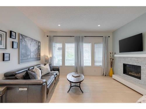 119 Marquis Green Se, Calgary, AB - Indoor Photo Showing Living Room With Fireplace