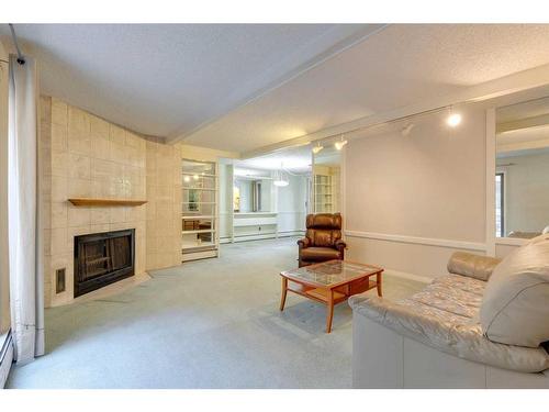 104-220 26 Avenue Sw, Calgary, AB - Indoor Photo Showing Living Room With Fireplace