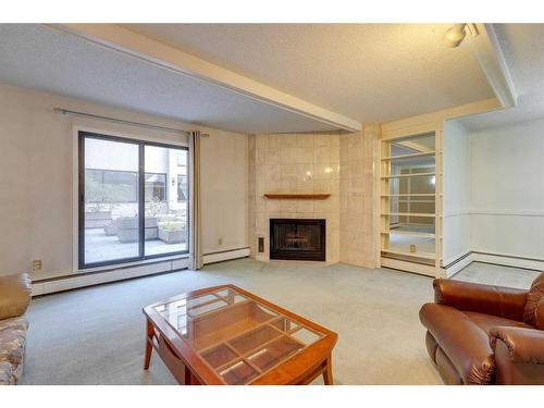 104-220 26 Avenue Sw, Calgary, AB - Indoor Photo Showing Living Room With Fireplace