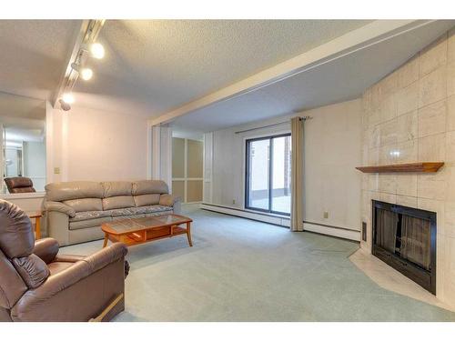 104-220 26 Avenue Sw, Calgary, AB - Indoor Photo Showing Living Room With Fireplace